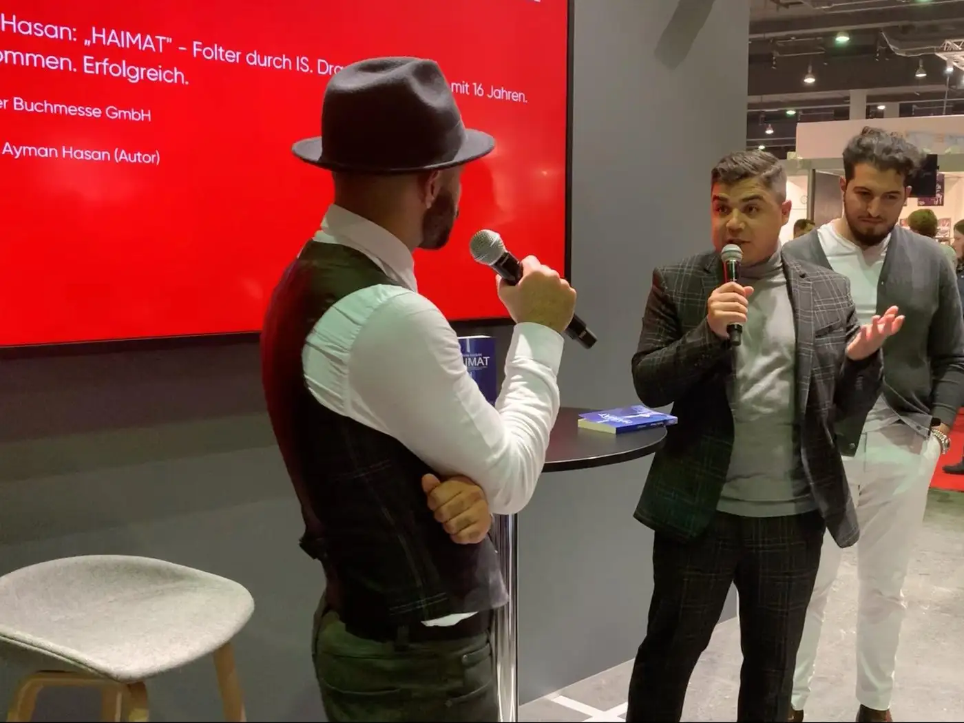 Ayman Hasan speaking about HAIMAT at the Frankfurt Book Fair 2019